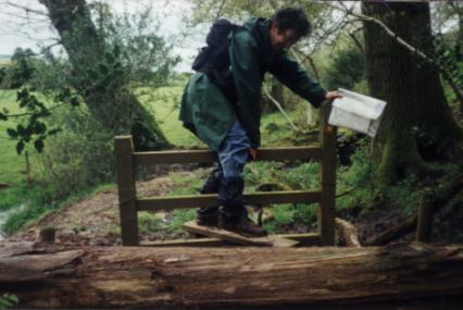 Crossing a stile between two very muddy fields